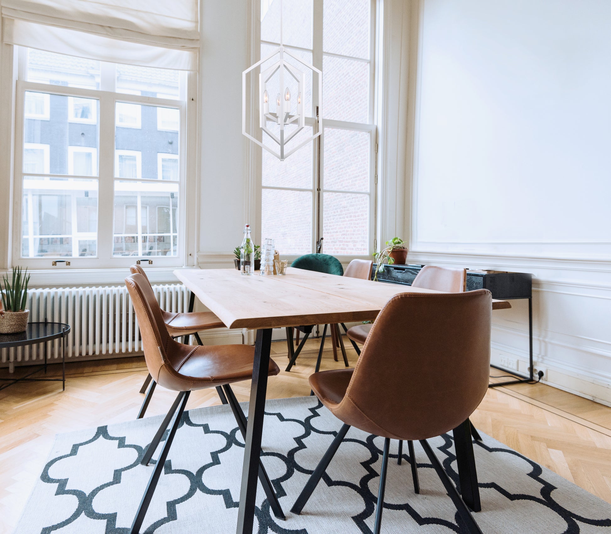 dining room table with contemporary light fixture above table