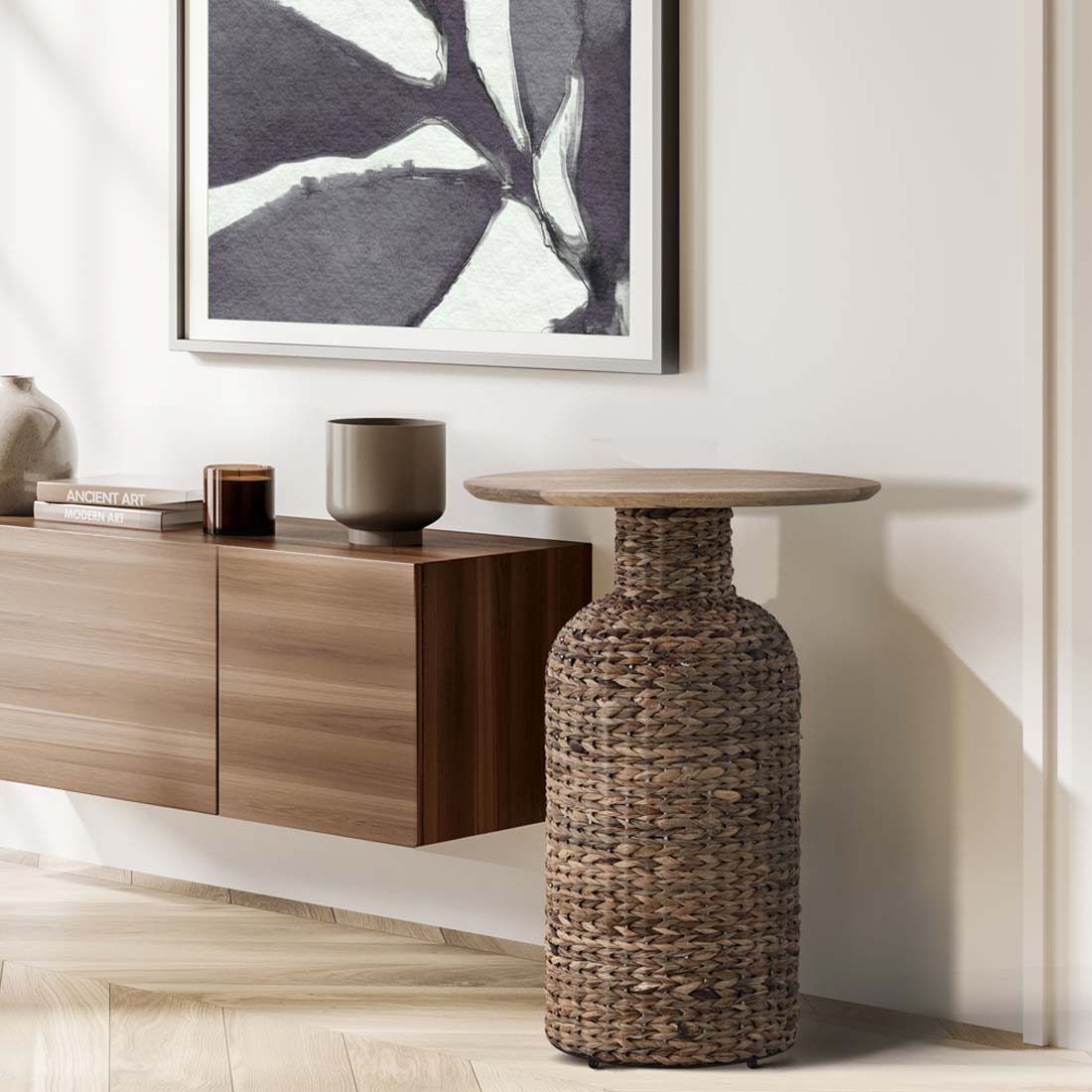 Load video: video showing close ups of a side table with a seagrass base and a multi-panel wooden top